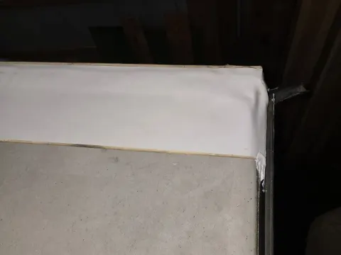 This image here is showing the cover tape being wrapped over the edge down into the edge of the gutter preventing any moisture or water penetrating behind the termination bar on the rear camper